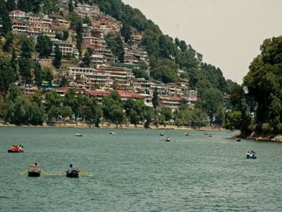Scenic view of Naini Lake surrounded by hills in Nainital, India.