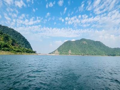 Gobind Sagar Lake with calm blue water and surrounding hills