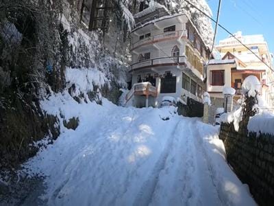 Snow-covered road in Manali during heavy snowfall