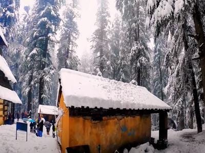 Traditional house in Manali covered with fresh snow