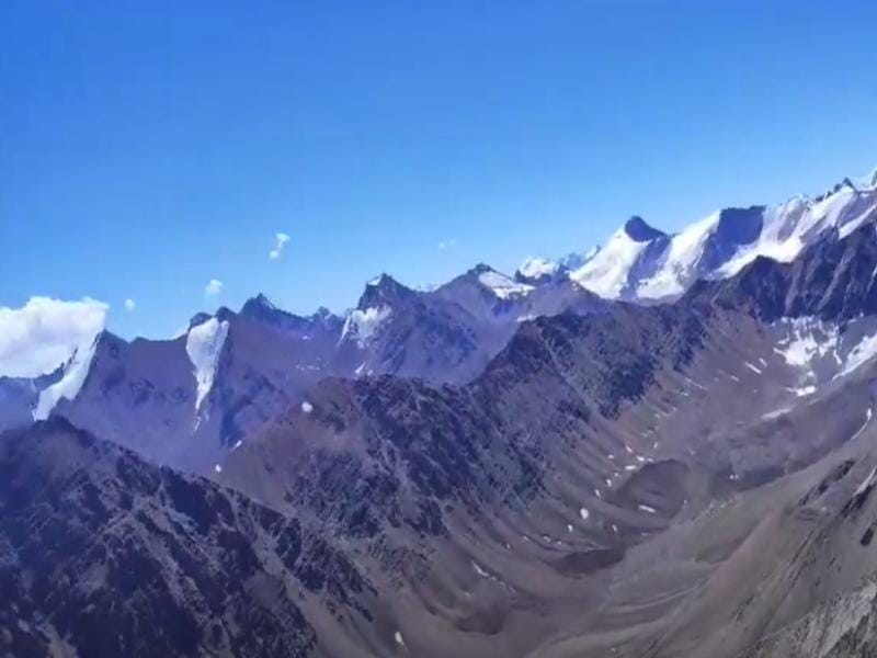 High-altitude view of trekkers crossing Charang-La Pass in the remote Kinnaur valley.